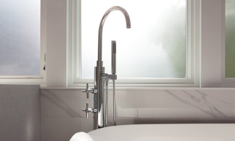 Faucet for freestanding tub in bathroom of Toronto home renovation by SevernWoods