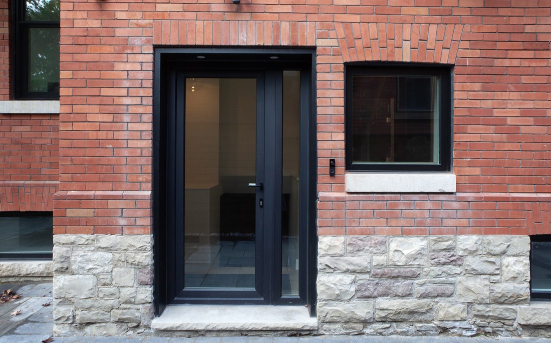 Brick and stone veneer with door to custom home in Toronto by SevernWoods