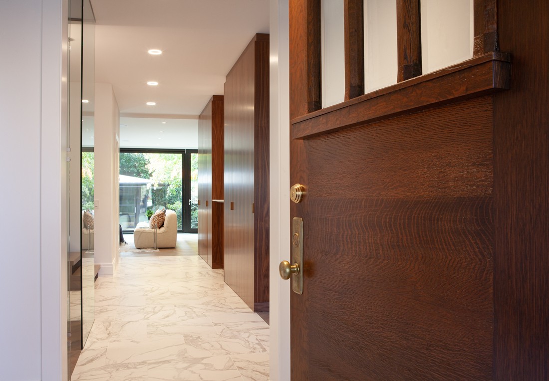 Door opening to custom home in Rosedale, Toronto with stone flooring