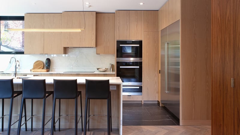 Four black bar stools at kitchen island in luxury Rosedale, Toronto custom home by SevernWoods