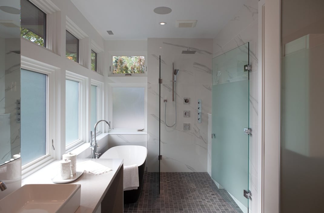 Primary bathroom with film windows and curbless shower & tub combo
