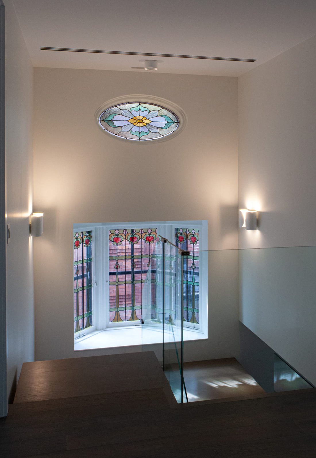 Stained glass window detailing with drywall finish in Toronto luxury custom home by SevernWoods