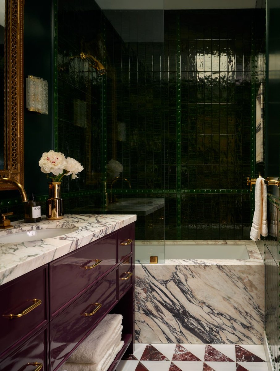 Luxurious bathroom with dark green tile shower, marble tub surround, and custom vanity in Toronto