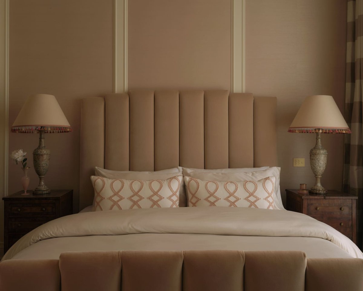 Neutral bedroom with upholstered headboard, twin nightstands, and soft lighting, located in Toronto