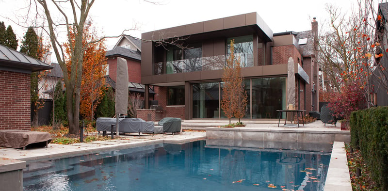 Backyard shot of addition and renovation in Toronto with pool by SevernWoods