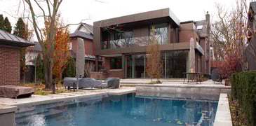 Backyard shot of addition and renovation in Toronto with pool by SevernWoods