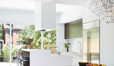 Luxury kitchen in Toronto with white cabinetry and multi-level-island