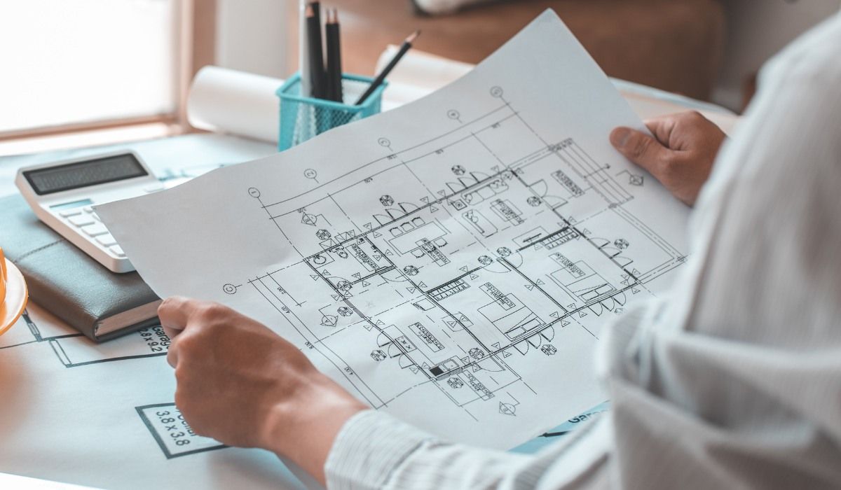 Residential Architect Looking at Floor Plan of Home