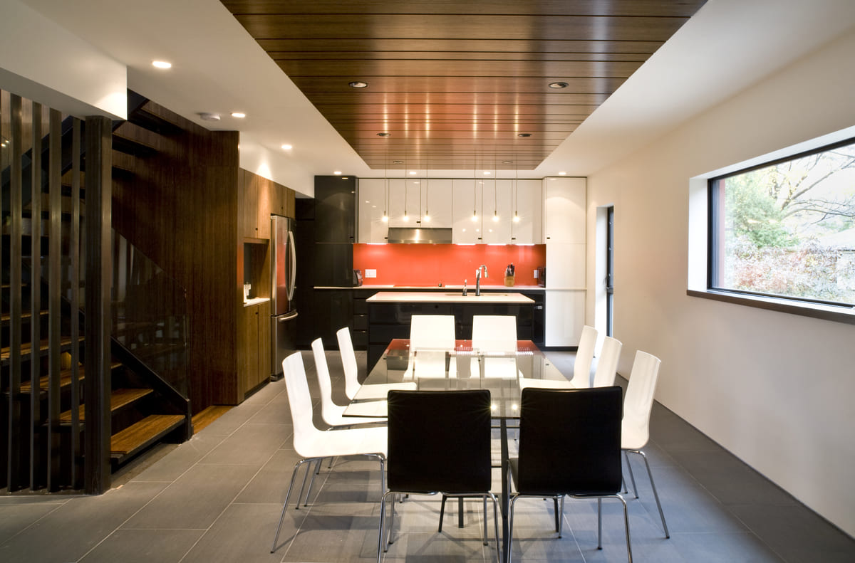 Contemporary kitchen with view of dining room table by SevernWoods Fine Homes