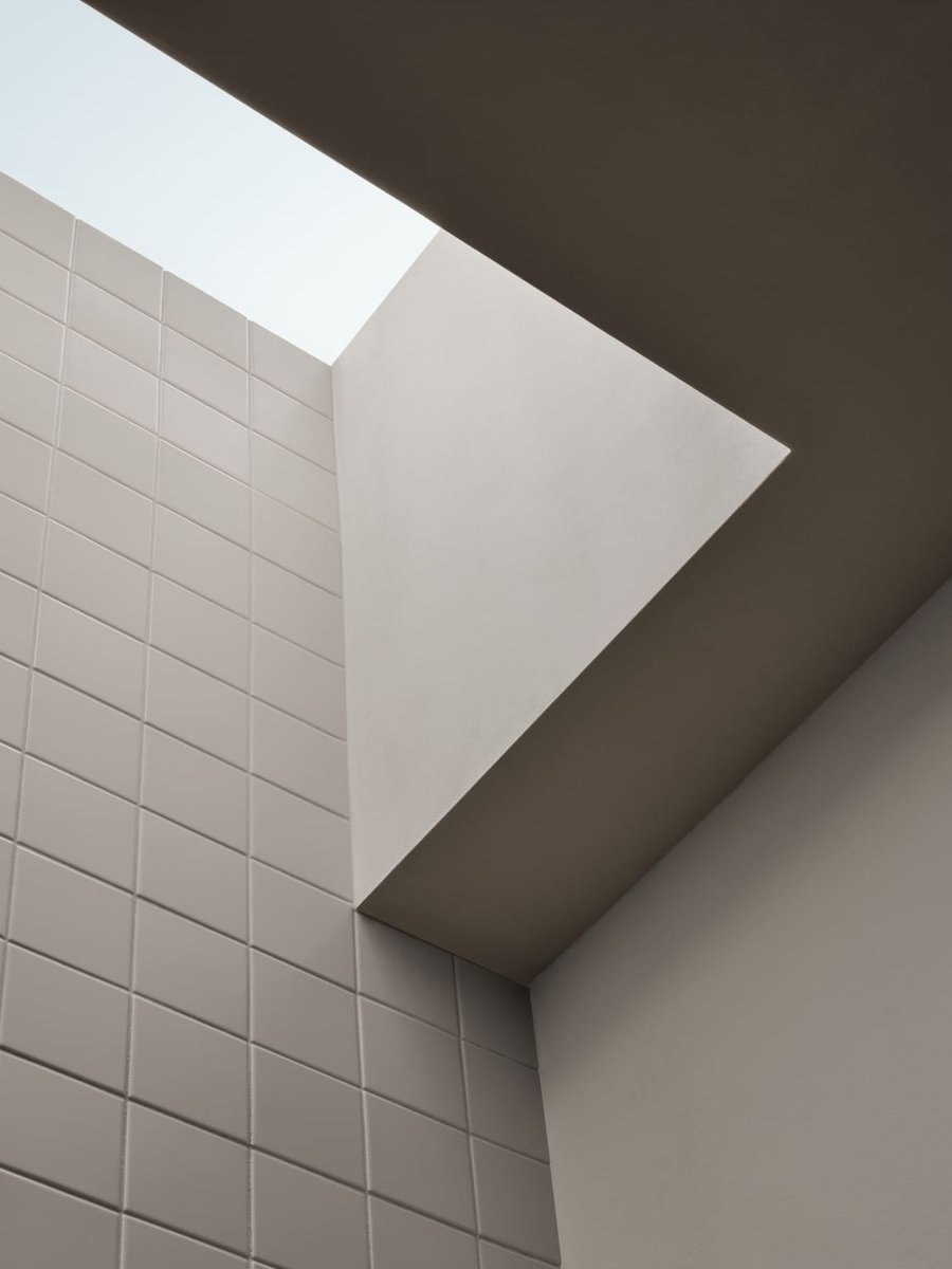 Toronto ceiling skylight detail with geometric opening and white tiled wall, highlighting modern minimalist design