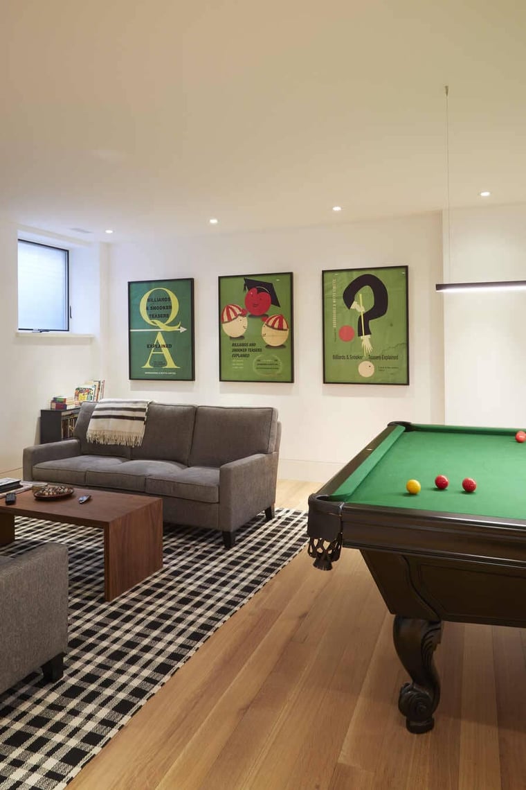 Custom basement layout with pool table and seating area in Toronto