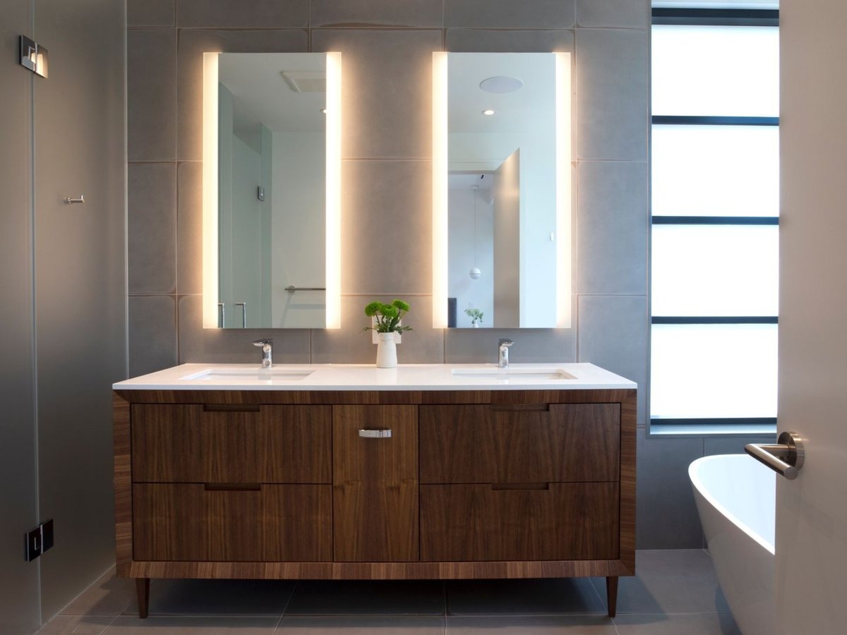 Custom double vanity with backlit mirrors in Toronto luxury home renovation by SevernWoods