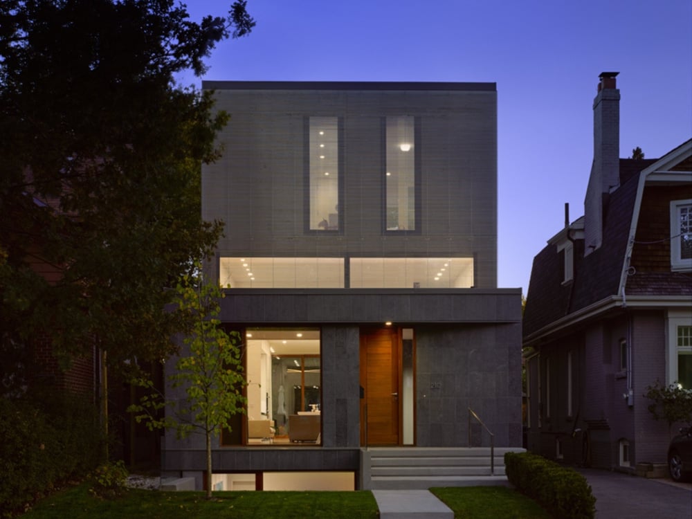 Custom home exterior front at dusk by SevernWoods