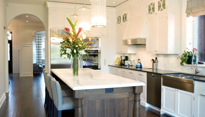 Elegant kitchen renovation with marble island, pendant lighting, and custom cabinetry located in Toronto
