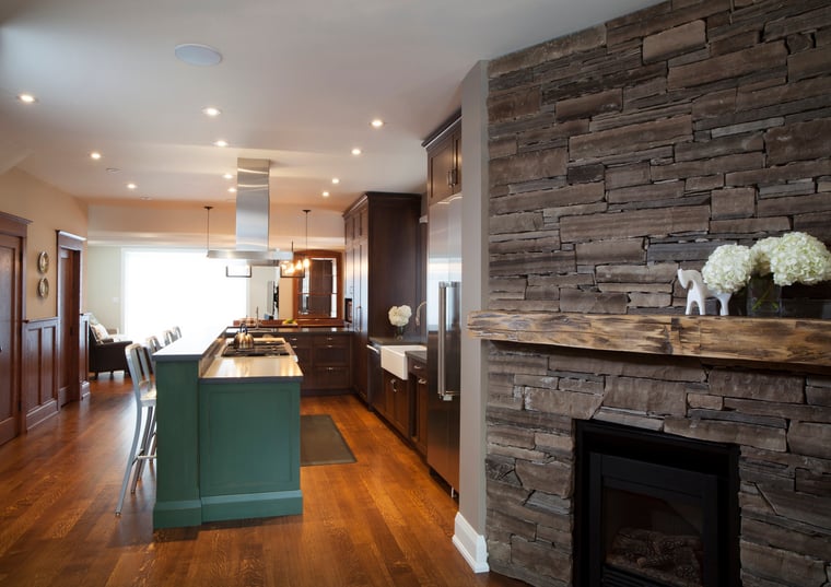 Fireplace and view of kitchen in Toronto renovation by SevernWoods