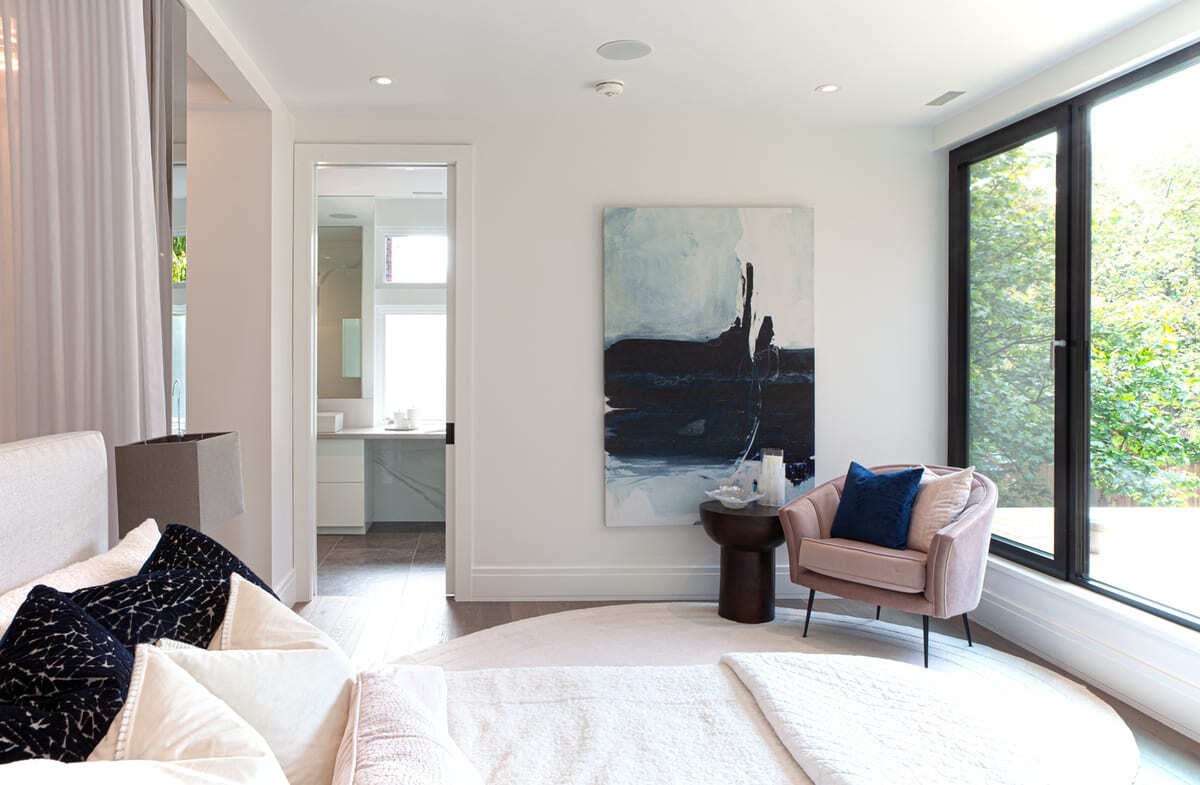 luxury-main-bedroom-in-toronto-home-renovation-with-ensuite-bathroom-through-door