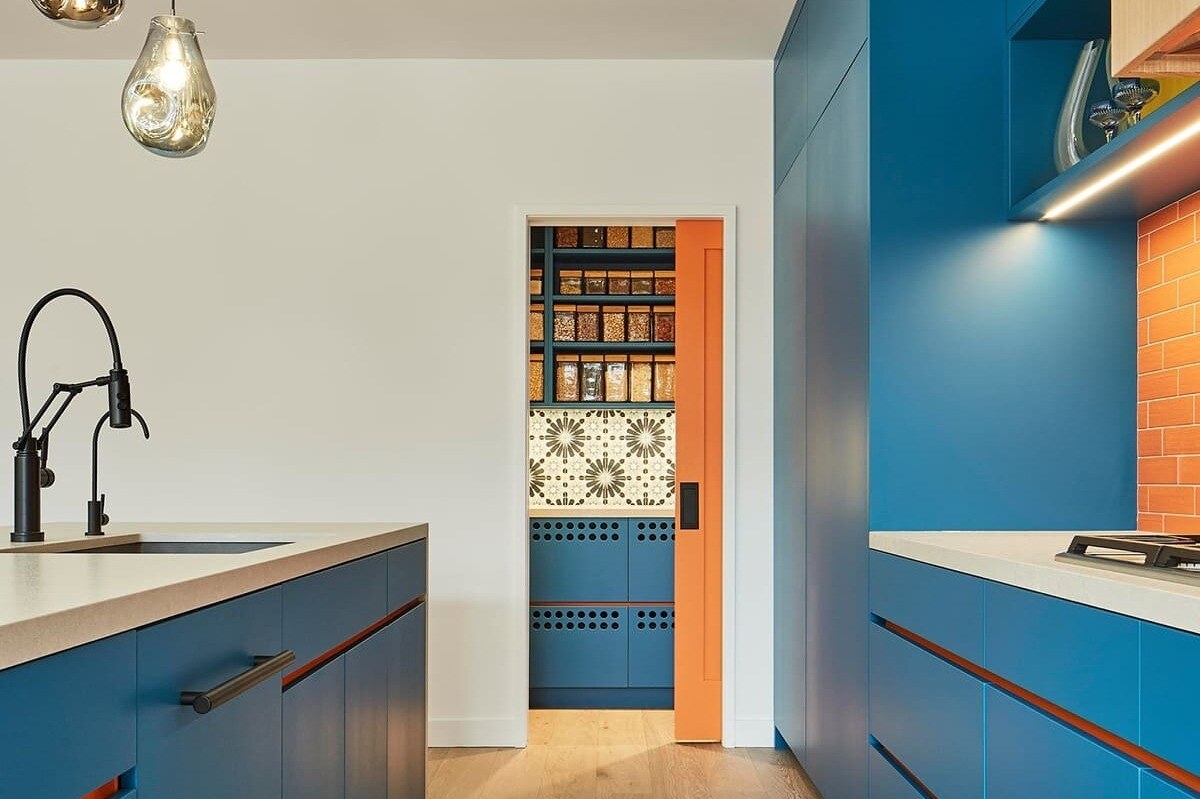 Blue flat panel cabinets with orange subway tile backsplash in Toronto home renovation by SevernWoods-1