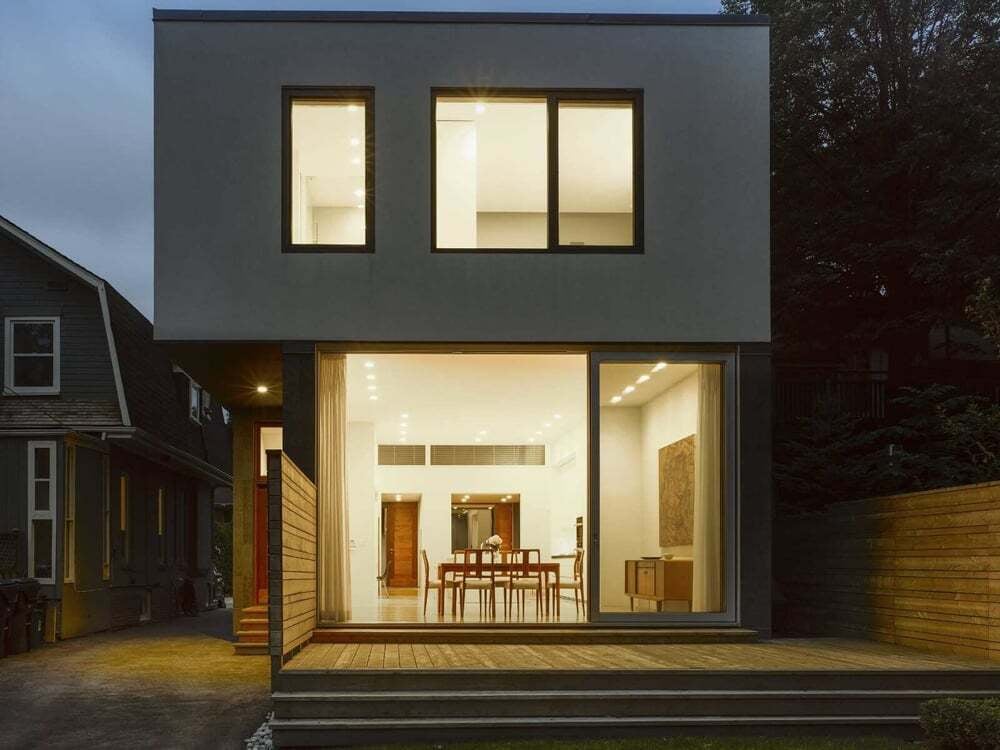 exterior-rear-night-stucco-glowing-windows-deck-counterpoint-severnwoods-toronto