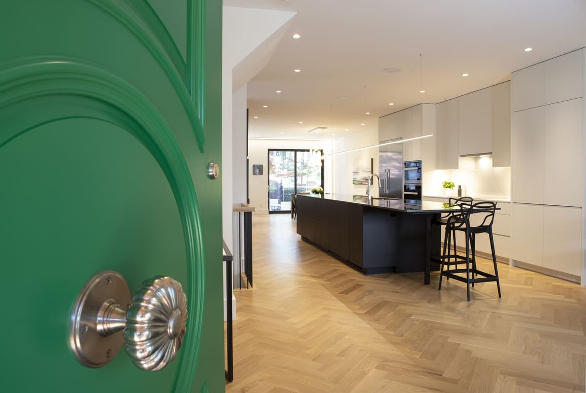 green-front-door-open-herringbone-kitchen-island-view-playter-estates-severnwoods-toronto