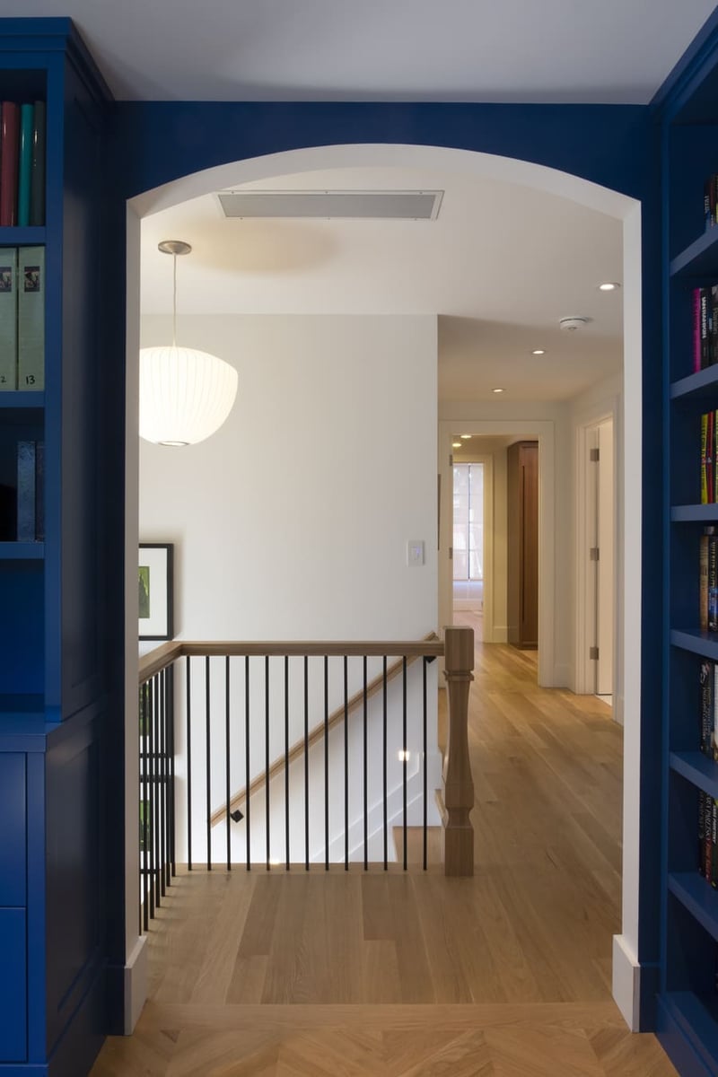 upstairs-hallway-arched-doorway-navy-bookshelves-staircase-playter-estates-severnwoods-toronto