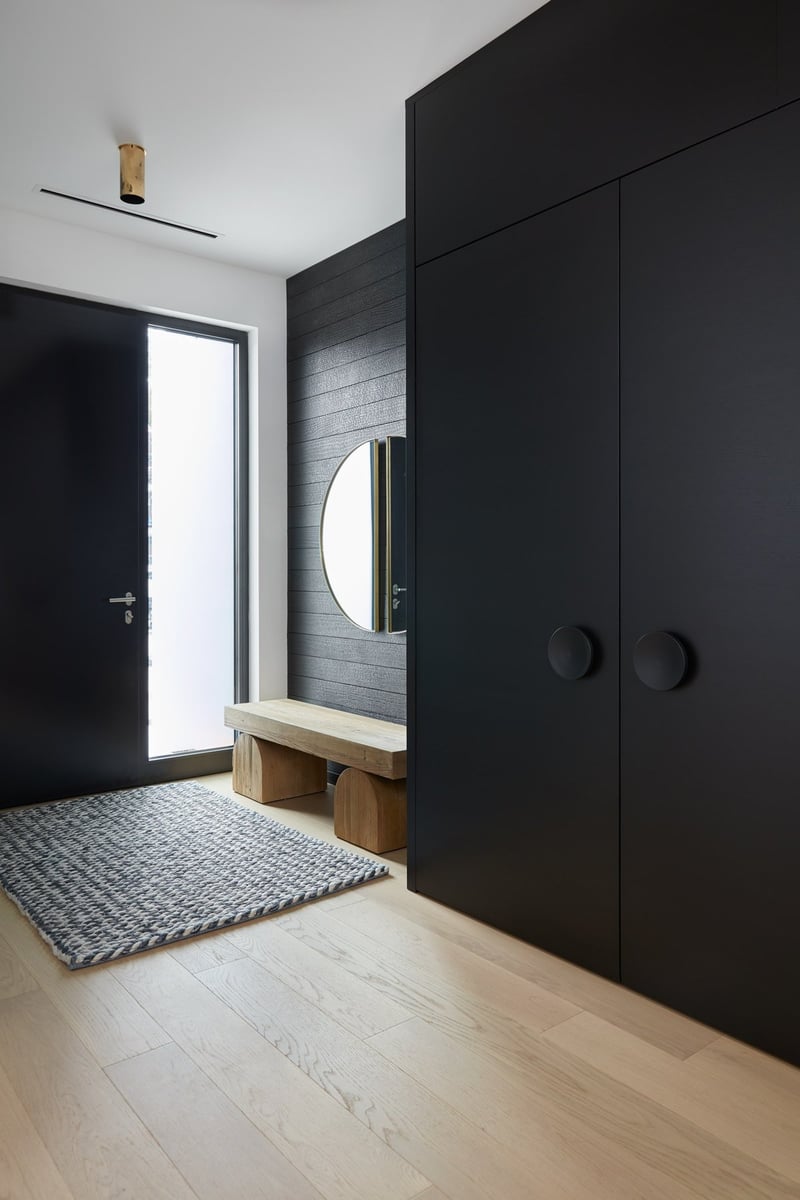 yakisugi-wood-in-entry-way-of-modern-home-with-circular-wooden-bench