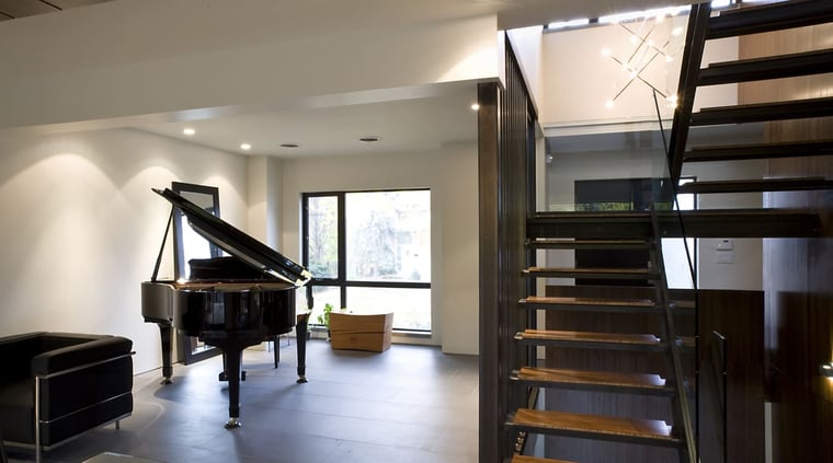 Grand piano near window in lower level of Toronto Home