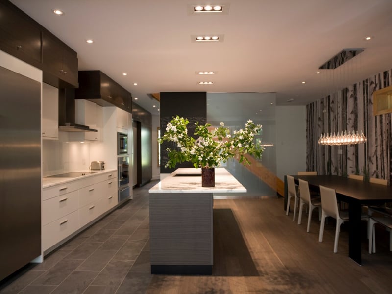 High-end contemporary kitchen renovation in Toronto with slab countertop on island