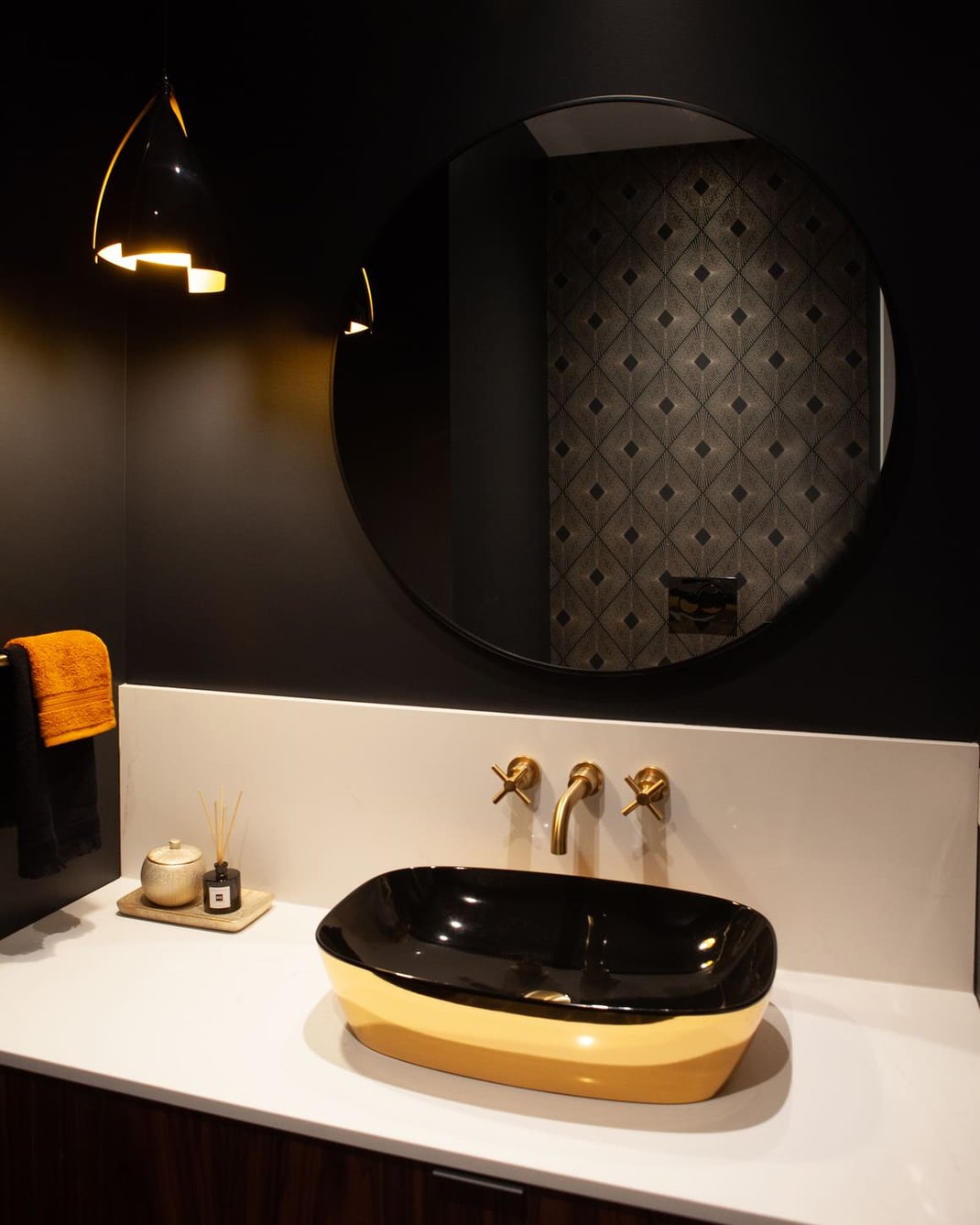 Luxury black and gold bathroom with vessel sink and round mirror by SevernWoods