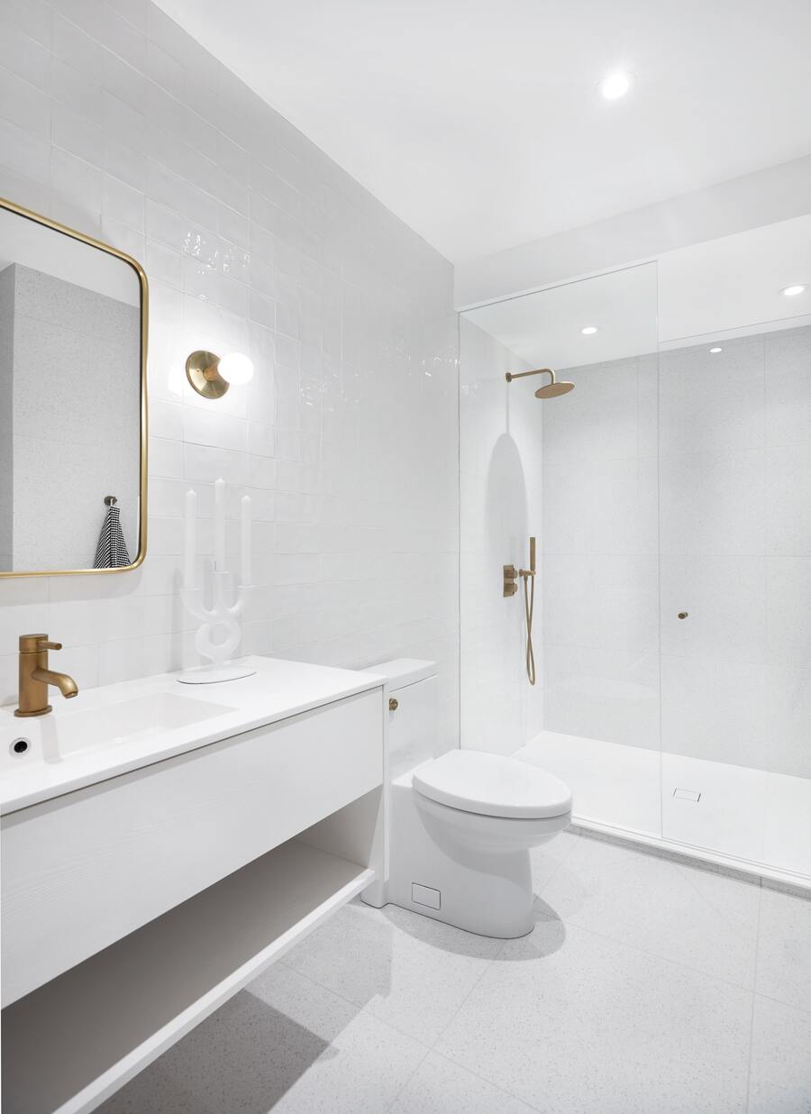 Minimal white bathroom renovation with walk-in shower with recessed lighting and tile flooring by SevernWoods Fine Homes