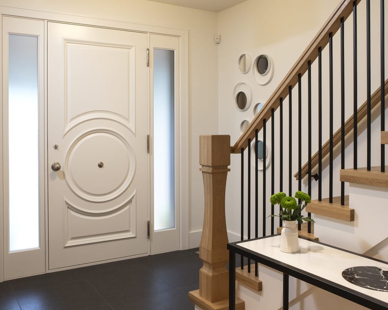 Modern entryway of Toronto home renovation with staircase in foyer