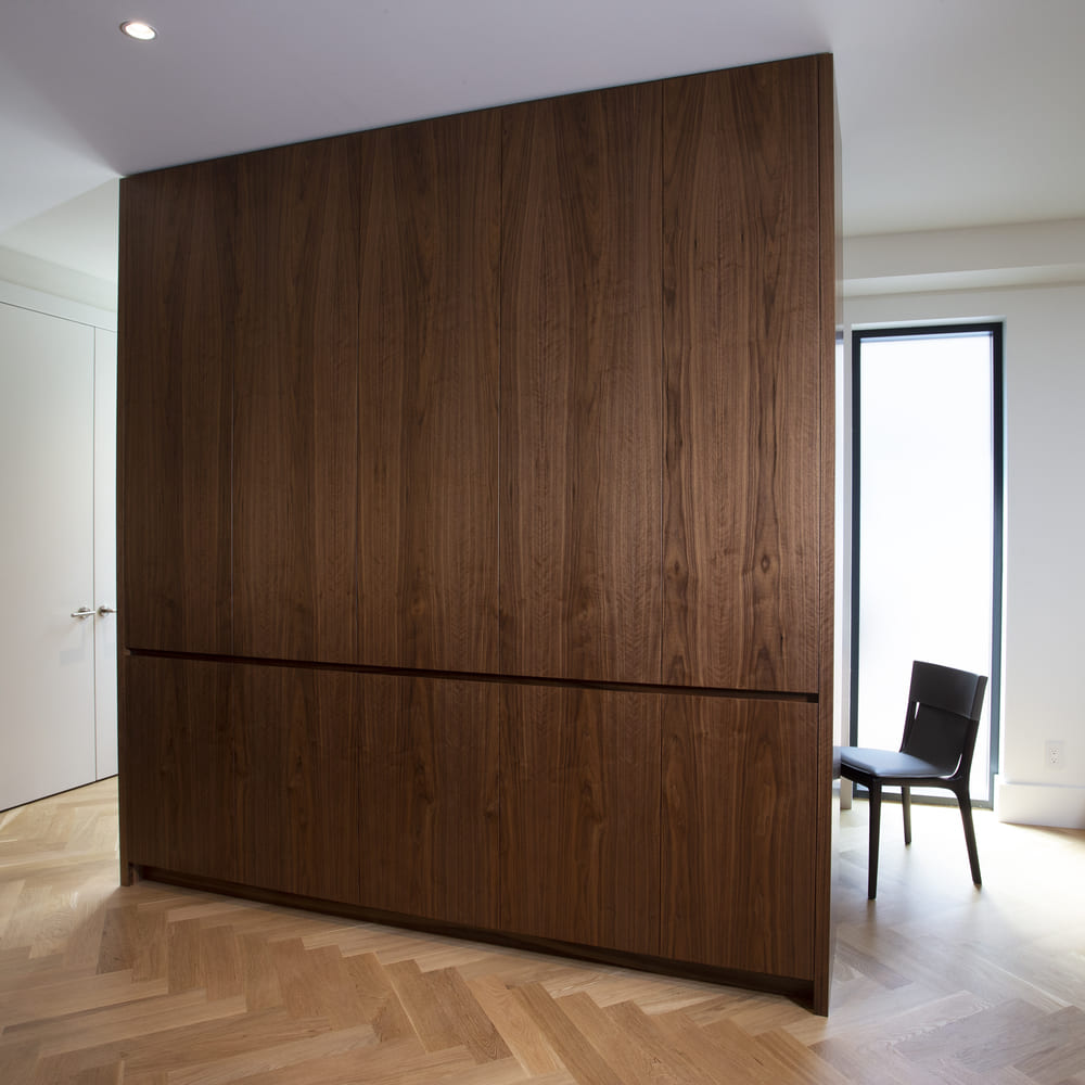 Playter Estates Toronto luxury home renovation with herringbone wood flooring and office chair behind cabintry