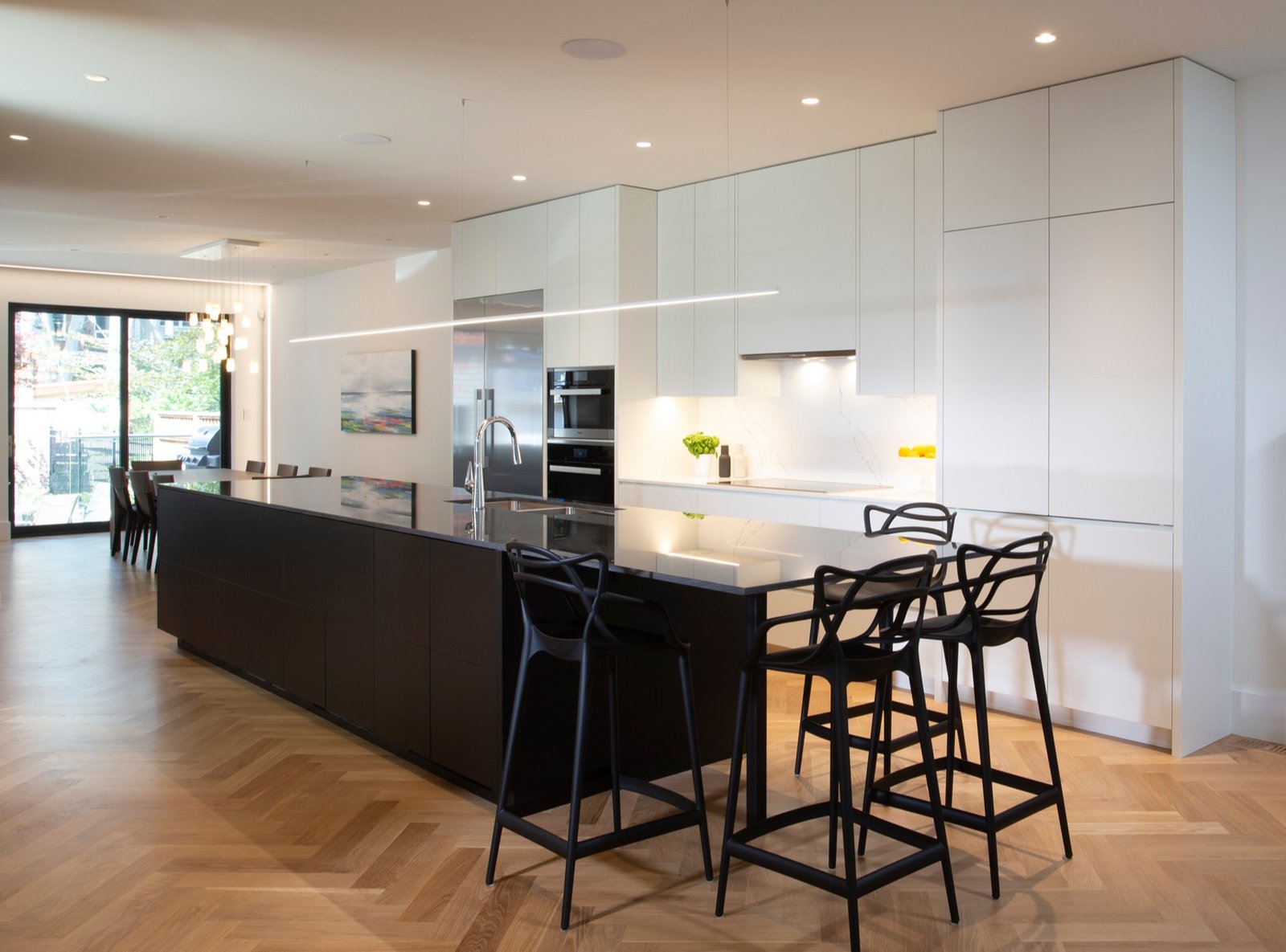 custom modern kitchen with herringbone flooring design an island and flush white cabinets
