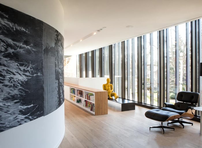 Toronto luxury custom home with curved wall with picture windows and Eames Lounge Chair and Ottoman