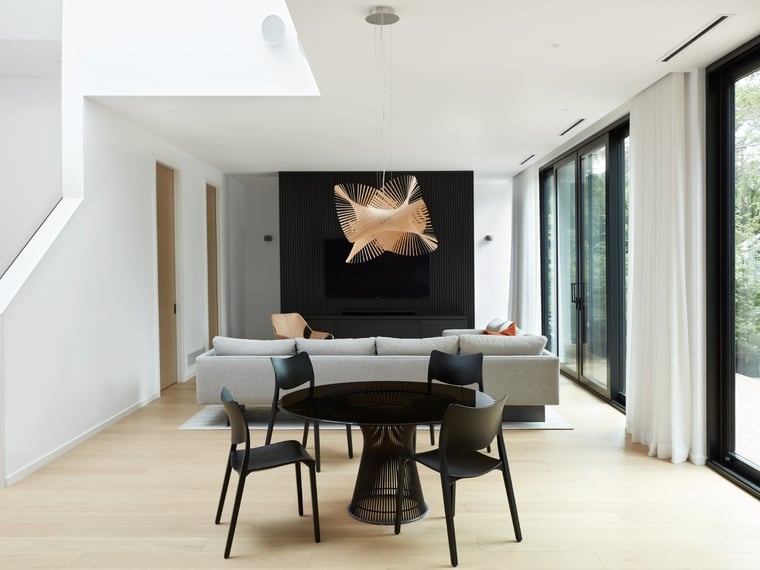 Toronto Japandi-style custom home dining room table with spiral pendant fixture by SevernWoods