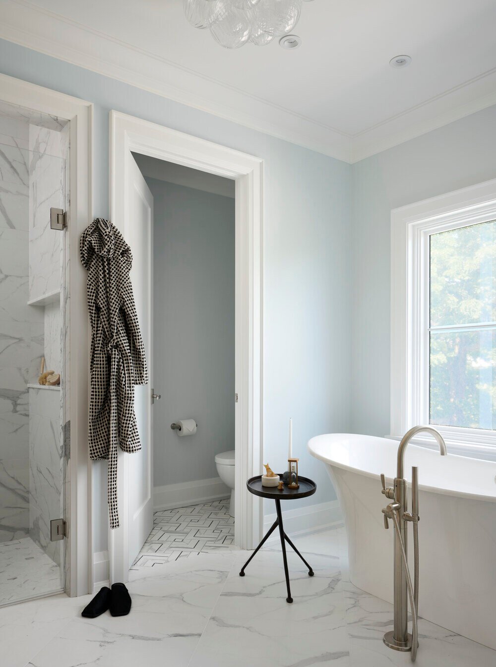 Bathroom with freestanding tub and marble flooring in SevernWoods Toronto home, photographed by Alex Lukey Photography