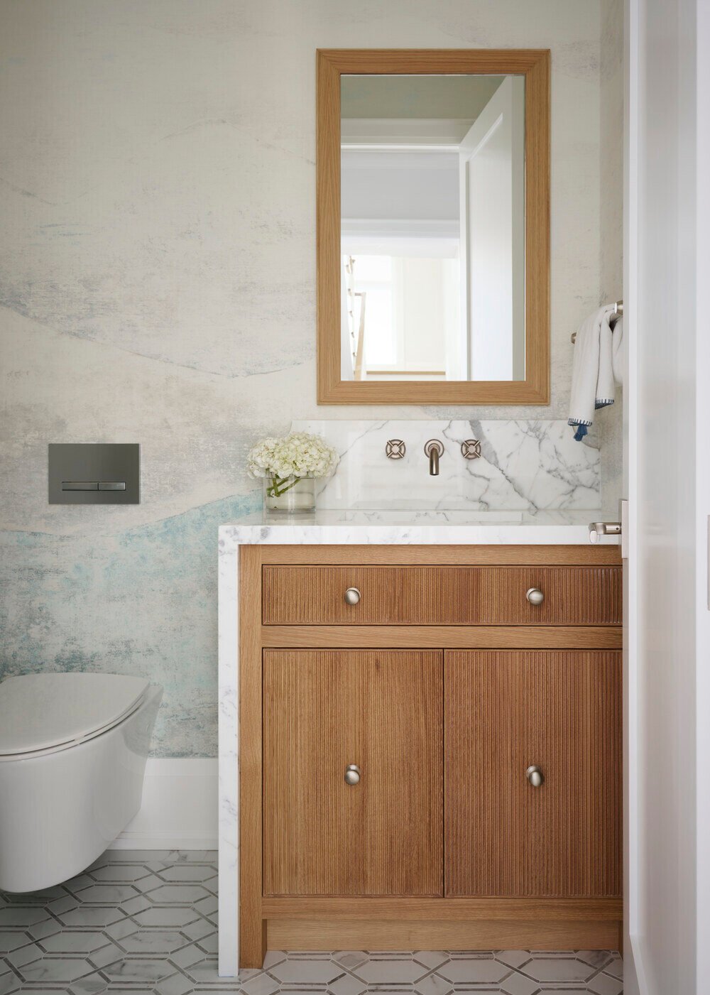 Contemporary powder room with floating marble vanity and textured wall in Toronto home by SevernWoods, photographed by Alex Lukey Photography