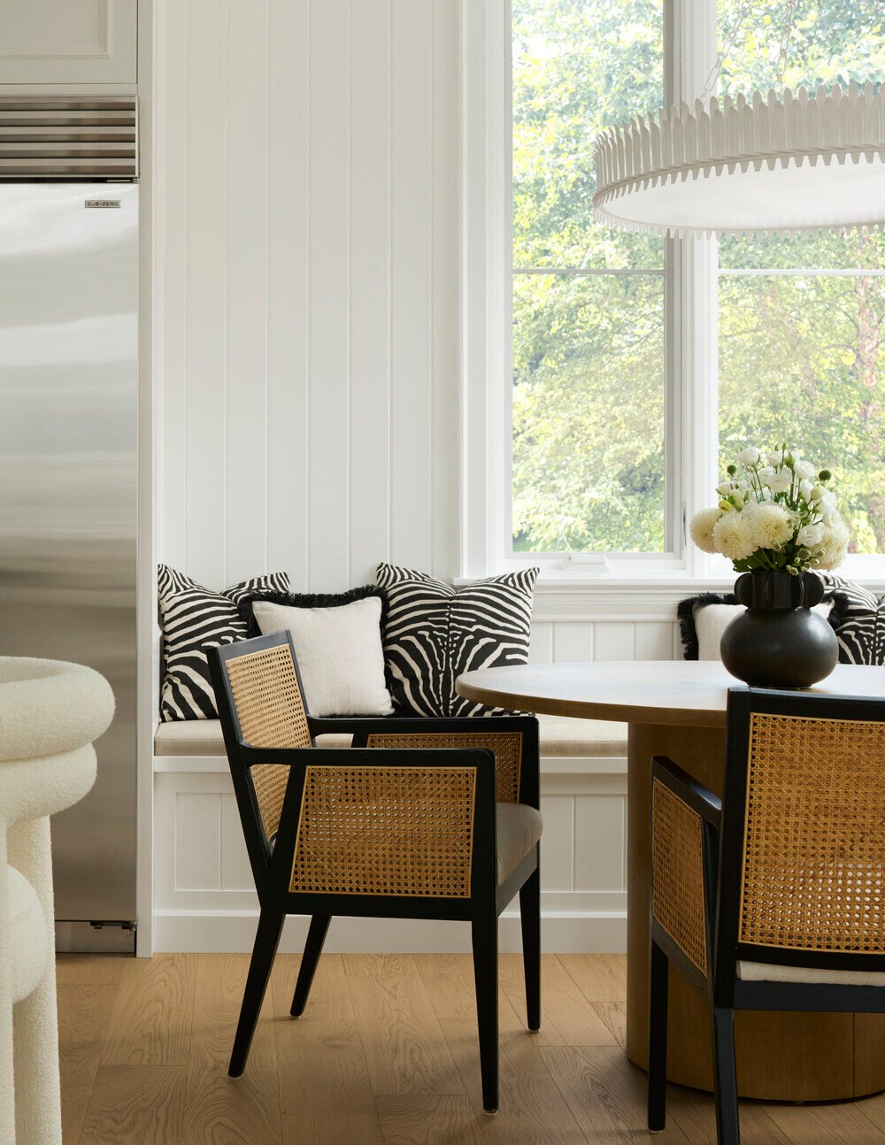 Dining table and chairs with statement lighting in Toronto custom home by SevernWoods, photographed by Alex Lukey Photography