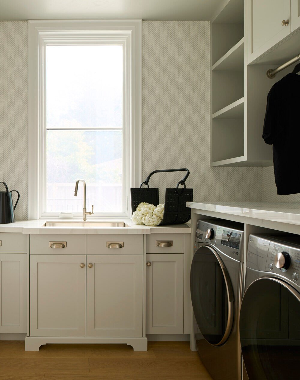 Dual washer-dryer setup with farmhouse sink in luxury custom Toronto home by SevernWoods Fine Homes, photographed by Alex Lukey Photography