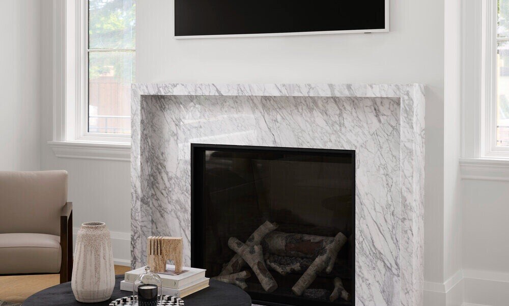 Fireplace with stonework by Select Surfaces Corp and TV wall in SevernWoods luxury Toronto custom home photographed by Alex Lukey Photography