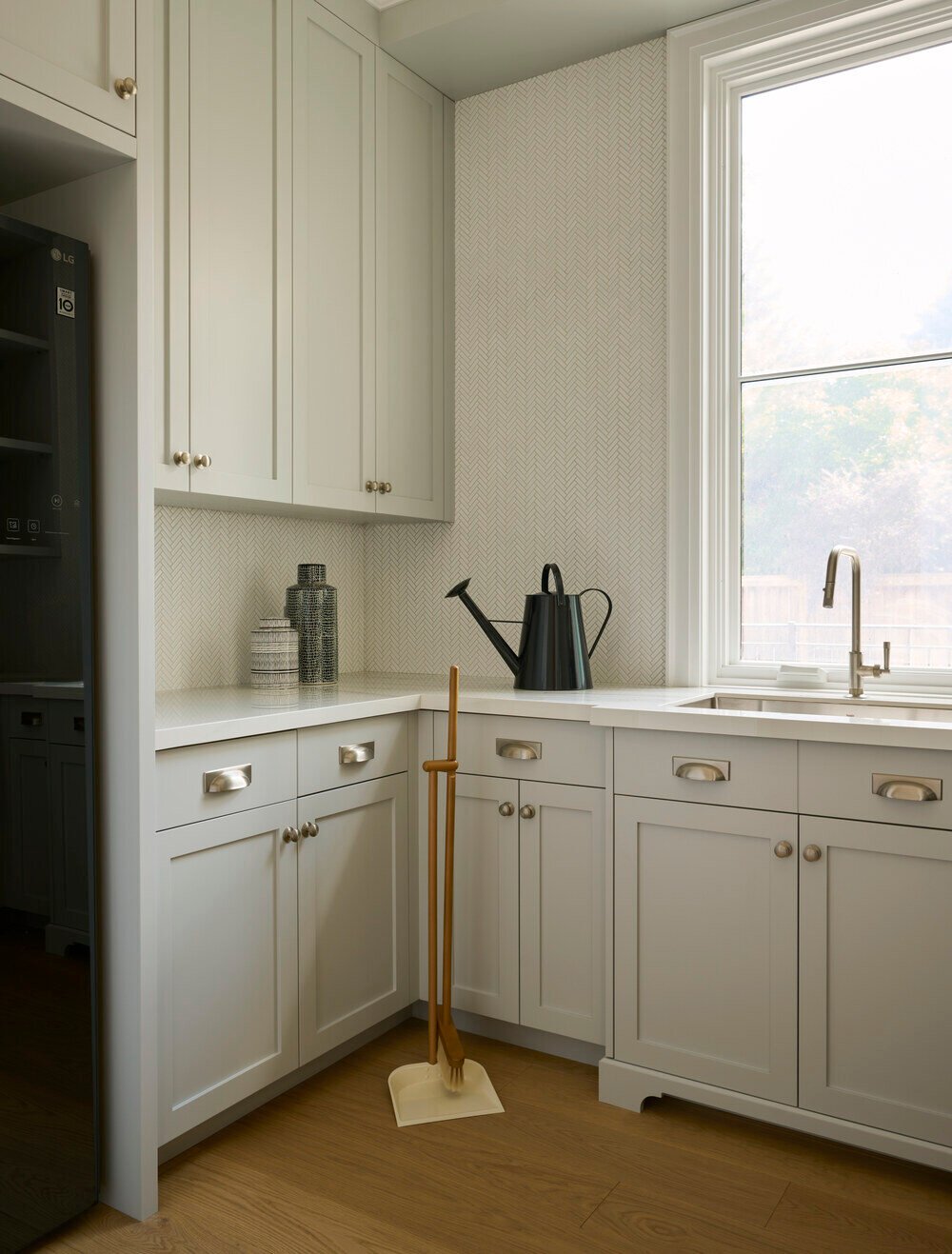Laundry room cabinetry with fixtures by Cesario and Co in SevernWoods Fine Homes luxury build in Toronto, photographed by Alex Lukey Photography