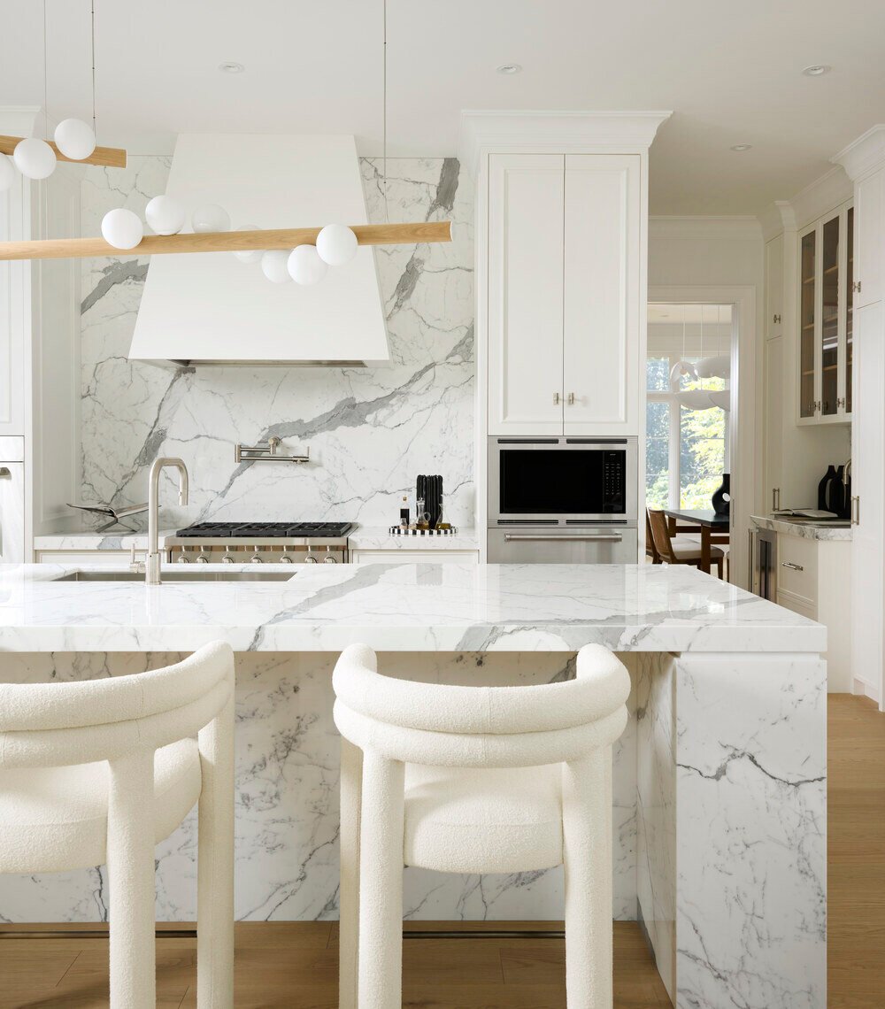 Waterfall island and statement lighting in SevernWoods luxury kitchen, Toronto, photographed by Alex Lukey Photography