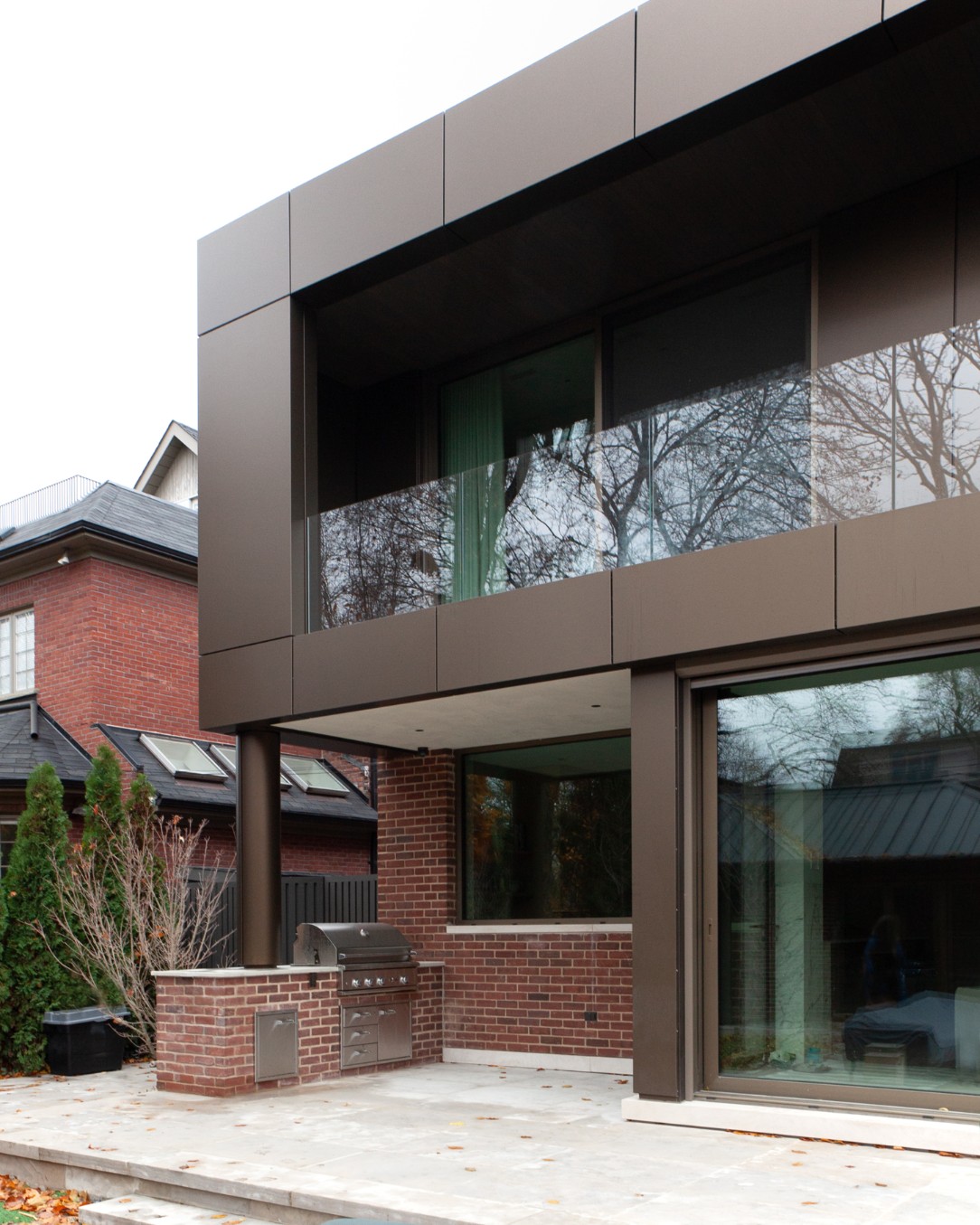 ACM cladding and modern floor-to-ceiling windows on Georgian-style addition and renovation in Toronto