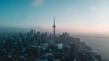 aerial shot of toronto with cn tower tall buildings and lake erie for weekend getaways near toronto