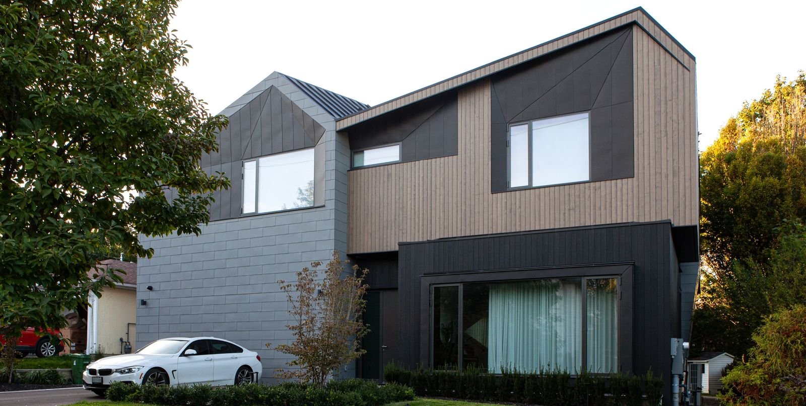 architectural designed toronto modern home front exterior with flush garage zinc cladding