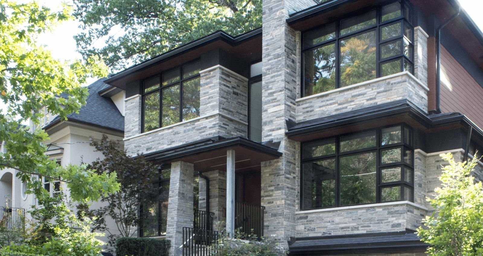 archtict designed old toronto stone home exterior with lots of windows