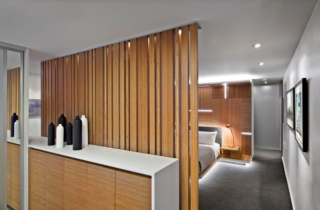 Luxury bathroom leading into bedroom with custom led lighting