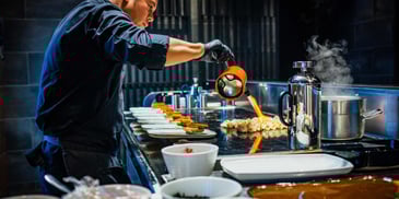 best fine dinning experiences in toronto with cook blow torching food on flat top