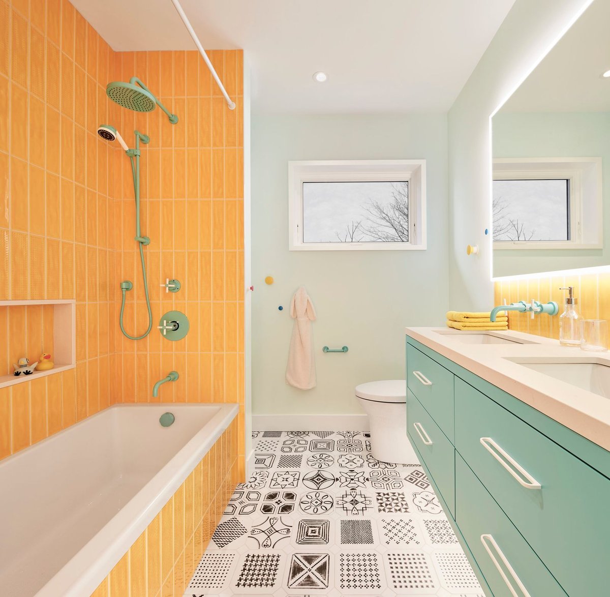 Contemporary kids bathroom with vertical yellow subway tiling and backlit mirror