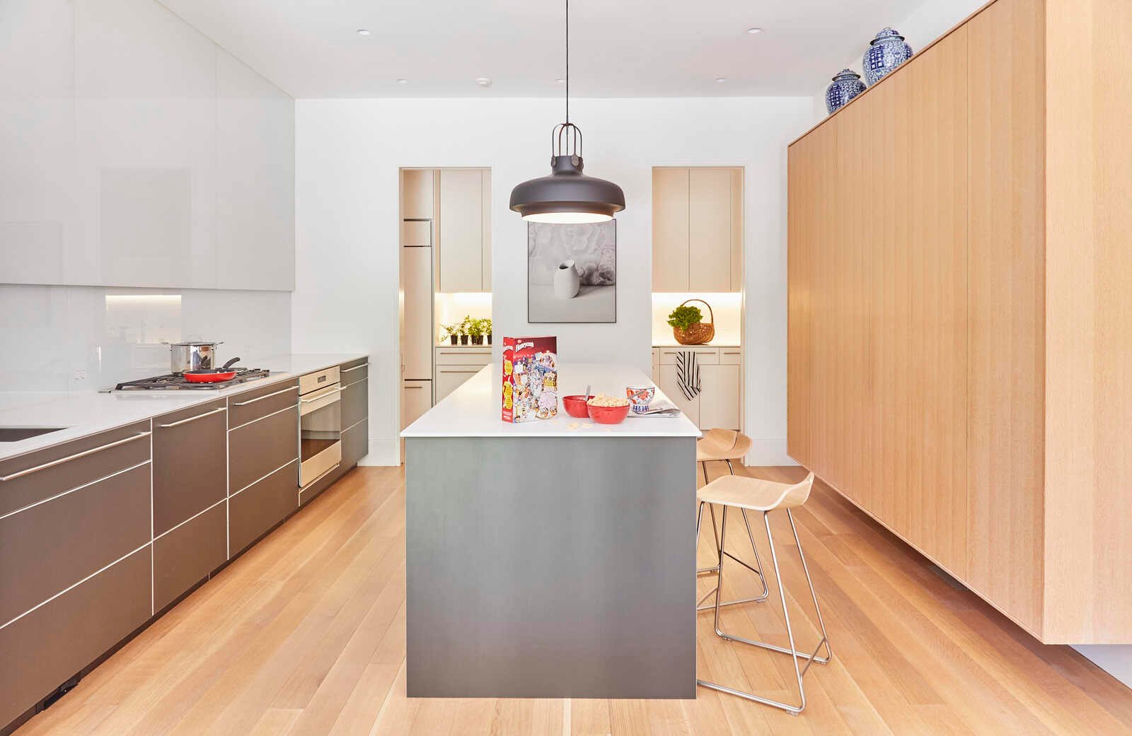 Contemporary custom kitchen with flat panel cabinetry and island