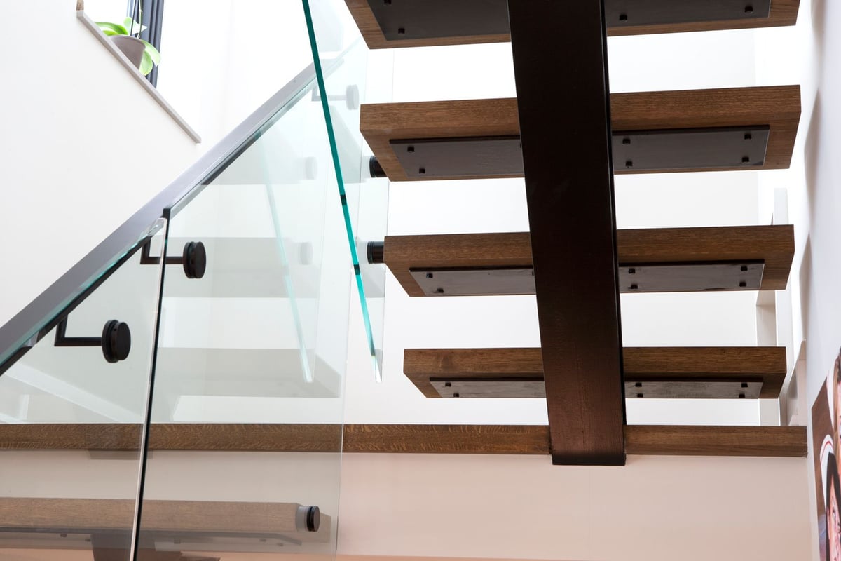 Contemporary floating stairs with custom glass siding